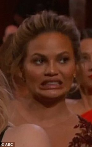 Chrissy Teigen cringing at Chris Rock's opening monologue.