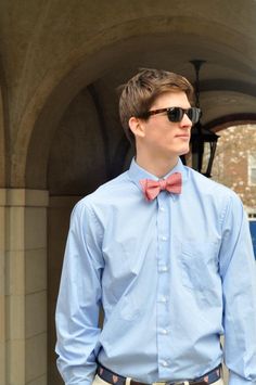 This boy models a semi-casual outfit with khakis, a dress shirt, and bowtie 